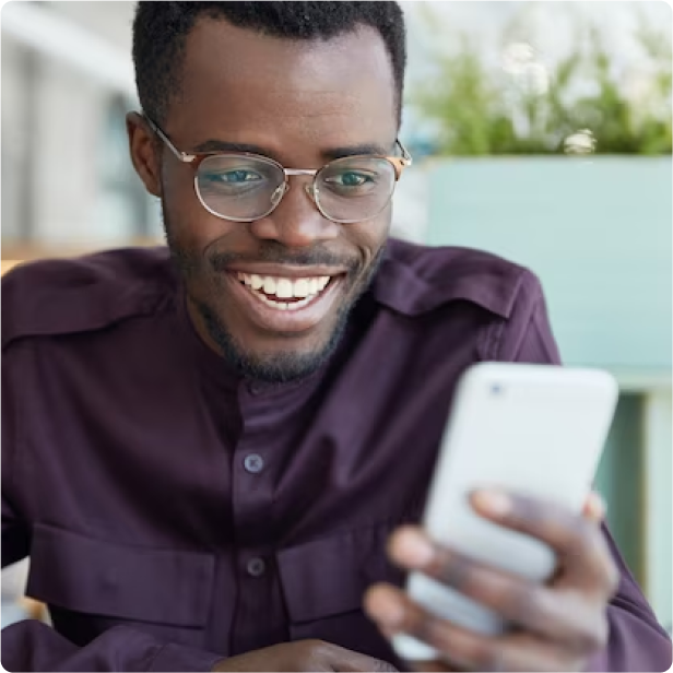 Man smiling looking at his phone